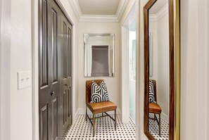 Stylish hallway with a chair and mirror.