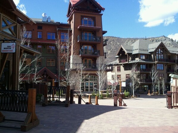 A multi-story lodge with balconies and a sign indicating it is a beginner's magic mountain resort.