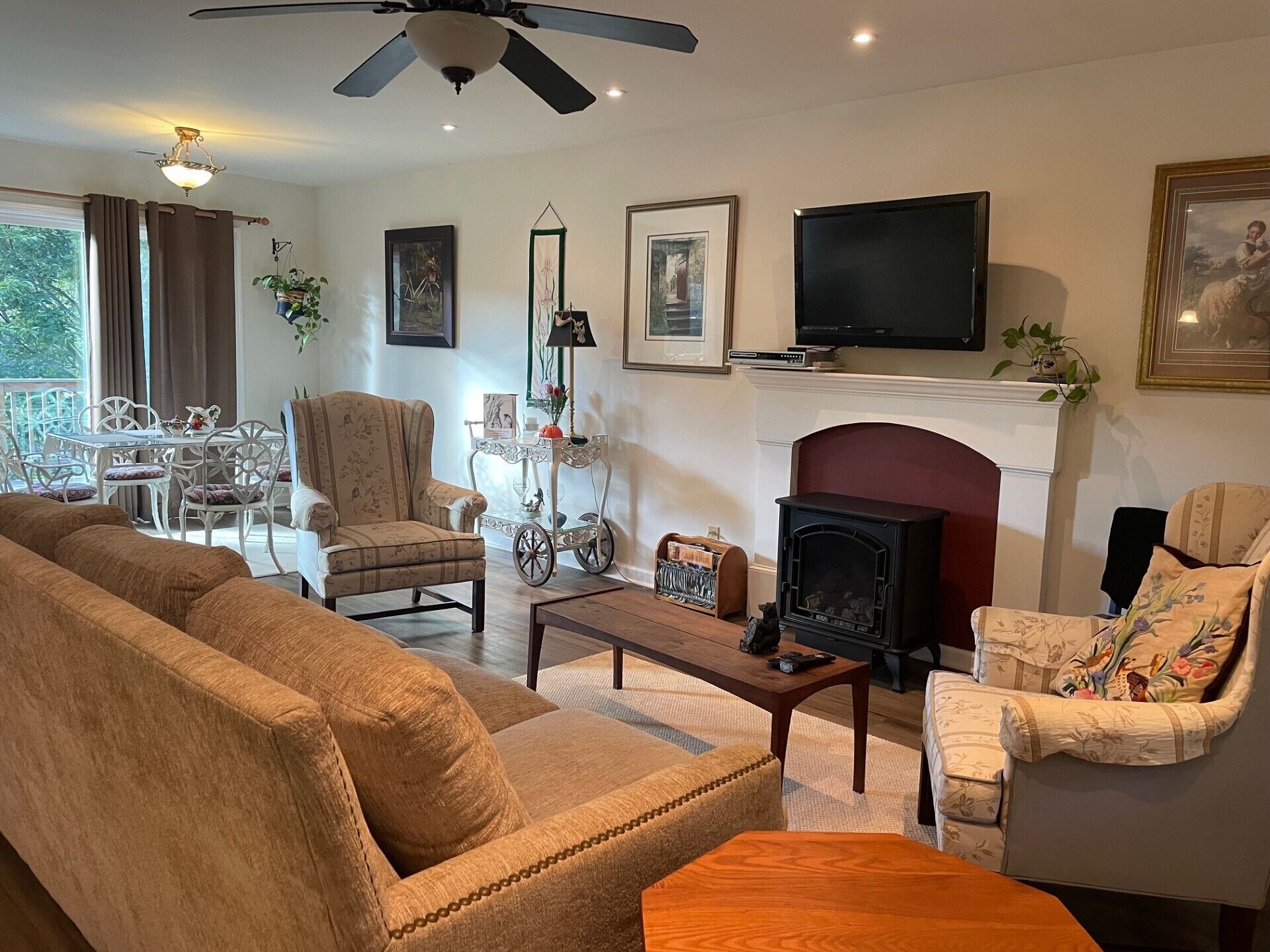 Living room with very comfy couch, propane stove and smart TV