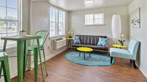 A room with a sofa, two chairs, a small table, and a round table. - Affordable for Long Stay, Great for Budget-Friendly Business Travels (Oklahoma City)