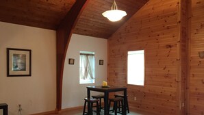 A wooden interior with a dining table, chairs, and a window. - Bring your boats, jetskis, and LARGE family - so much space inside and out (Sylvan Beach)