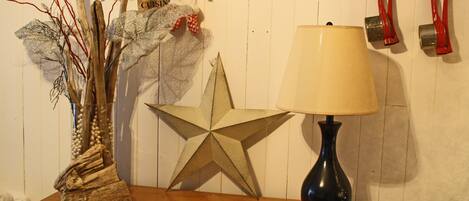 A wooden table with a star decoration, a lamp, and various hanging items.