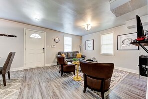 A living room with a sofa, chairs, a coffee table, and a TV. - Indie Escape-2 in 1- stone’s throw to the Plaza (Oklahoma City)