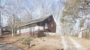 A wooden cabin with a balcony, surrounded by trees. - Quaint cottage in the Smoky Mountain area convenient to all the attractions (Kodak)