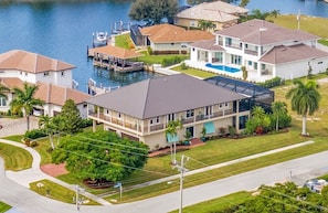 A residential area with houses, a dock, and a swimming pool.