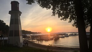 A lighthouse, a dock, and boats at sunset. - The Great Escape Sleeps 10 Comfortably (6 beds)  & Awesome Lake Views!  (Clear Lake)