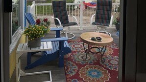 A balcony with two chairs, a small table, and a potted plant. - The Great Escape Sleeps 10 Comfortably (6 beds)  & Awesome Lake Views!  (Clear Lake)