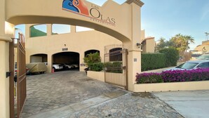 A gated entrance to a building with a sign reading "Las Olas Condominiums". - Costa Azul Oceanfront Condo w/Views, Surf, Swimmable Beach (San Jose del Cabo)