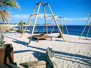 On the beach, sun-loungers