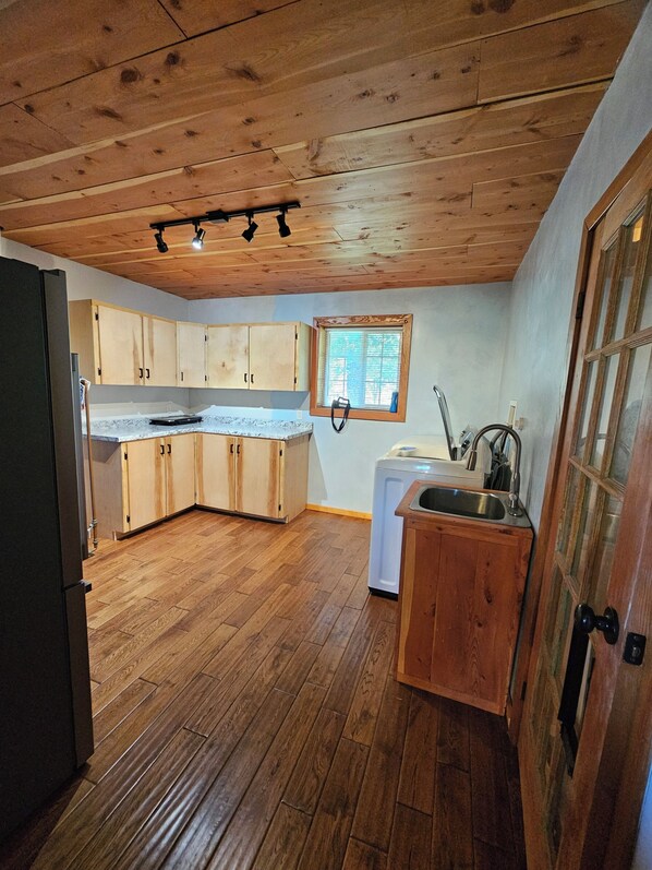 A kitchen with wooden cabinets, a built-in oven, and a window. - Mi Casa es tu Casa, 12 mi. from Sipapu Ski Area in the beautiful Penasco Valle (Penasco)