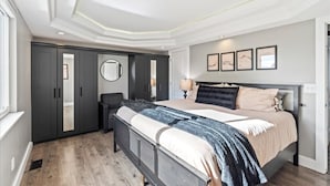 A bedroom with a bed, bedside table, lamp, and a wardrobe. - Hot Tub Gameroom Great Location Sparkling Clean (West Valley City)