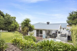 A residential property with a covered outdoor seating area, a swimming pool, and a well-maintained garden. - Lady Nelson, Sorrento - hot tub (SORRENTO)