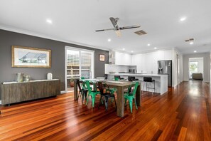 A modern kitchen with white cabinets, a built-in island, and a ceiling fan. - Lady Nelson, Sorrento - hot tub (SORRENTO)