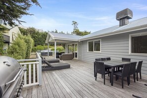 A deck with a grill, outdoor seating, and a covered patio area. - Lady Nelson, Sorrento - hot tub (SORRENTO)