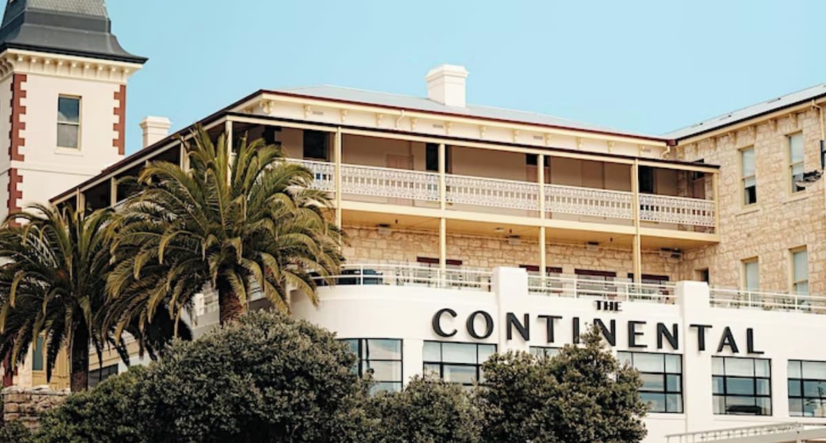 A multi-story building with balconies and a sign that reads 'CONTINENTAL'.