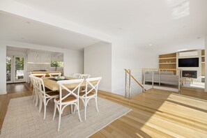A modern interior with a dining area, kitchen, and living space.