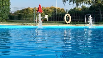 2 outdoor pools, open noon to 9 PM, pool umbrellas