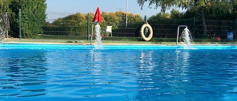 2 outdoor pools, open noon to 9 PM, pool umbrellas