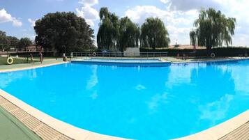 2 outdoor pools, open noon to 9 PM, pool umbrellas
