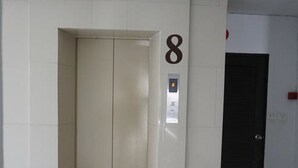 An elevator with a control panel and a door marked with the number 8. - Grand Seven Place (Pak Kret)
