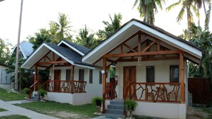 Two small, single-story houses with wooden balconies and a paved driveway. - D's Ocean View Beach Resort (Siquijor)