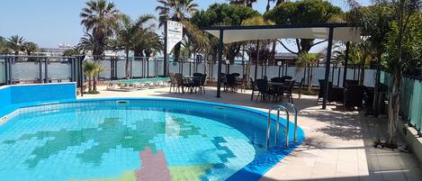 Seasonal outdoor pool, open 8 AM to 8 PM, pool umbrellas, pool loungers