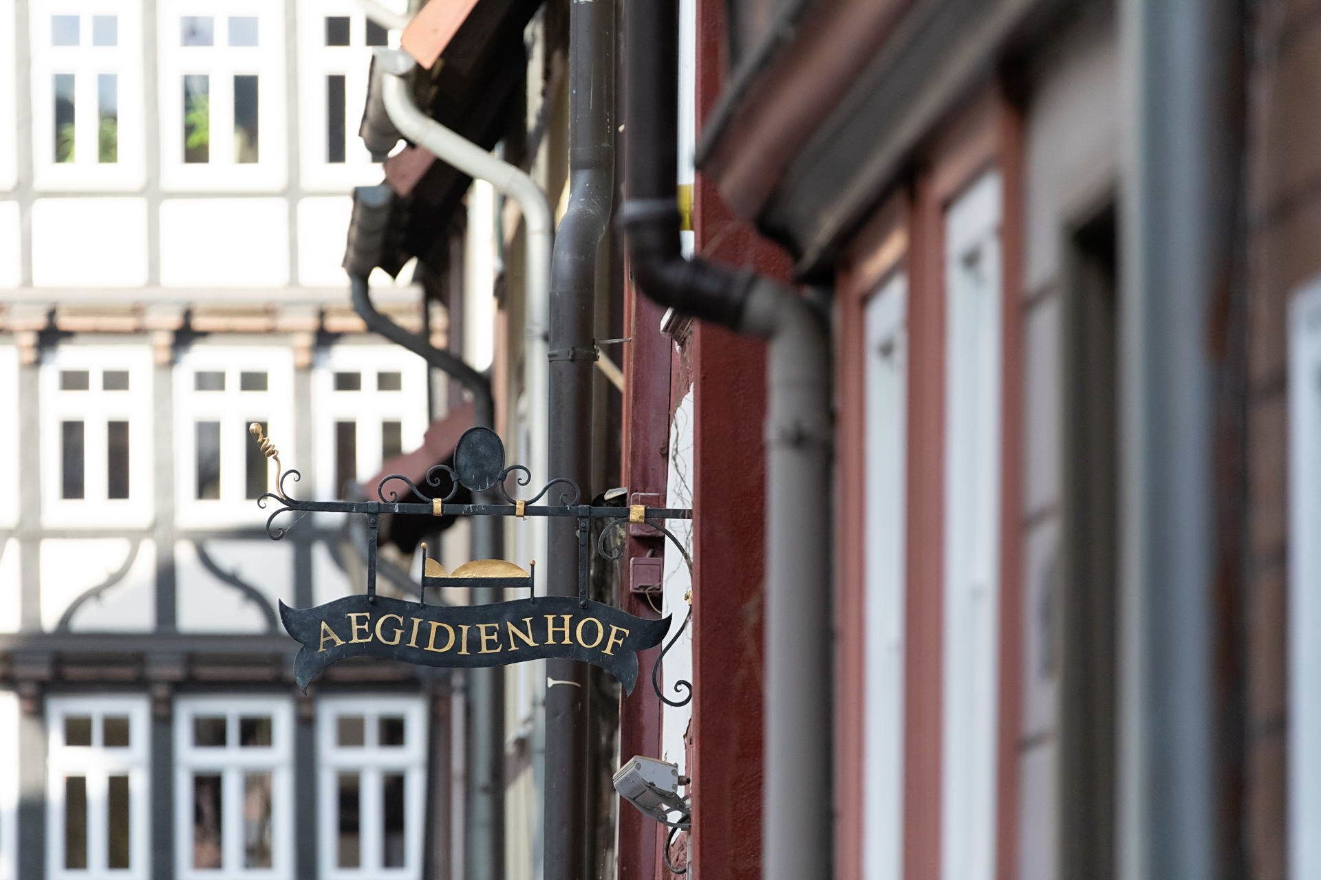 A sign with the name "AEGIDIENHOF" hanging from a building's exterior.