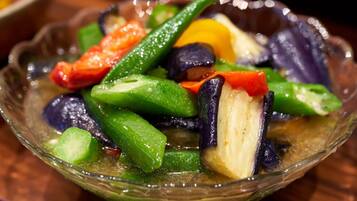 A bowl of stir-fried vegetables with visible pieces of green, red, and purple vegetables.