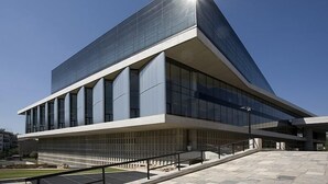 A modern building with a prominent glass facade and a sloped roof. - Nephiria, Under the Acropolis, In the heart of Plaka (Athens)