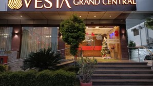 The exterior of Vesta Grand Central hotel with a prominent entrance, steps leading up to the lobby, and a Christmas tree decoration. -  Vesta Grand Central Udaipur (Udaipur)