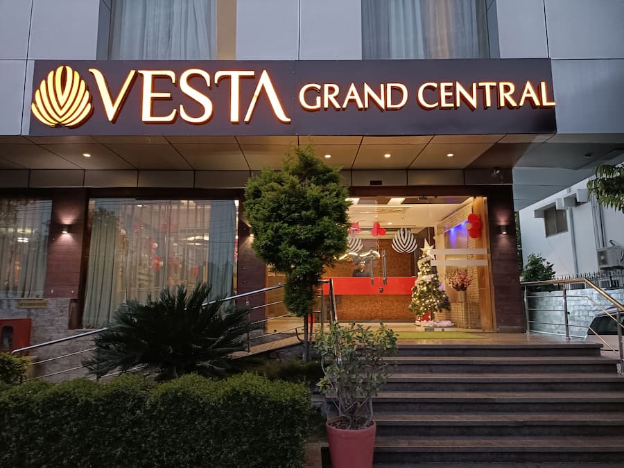 The exterior of Vesta Grand Central hotel with a prominent entrance, steps leading up to the lobby, and a Christmas tree decoration.