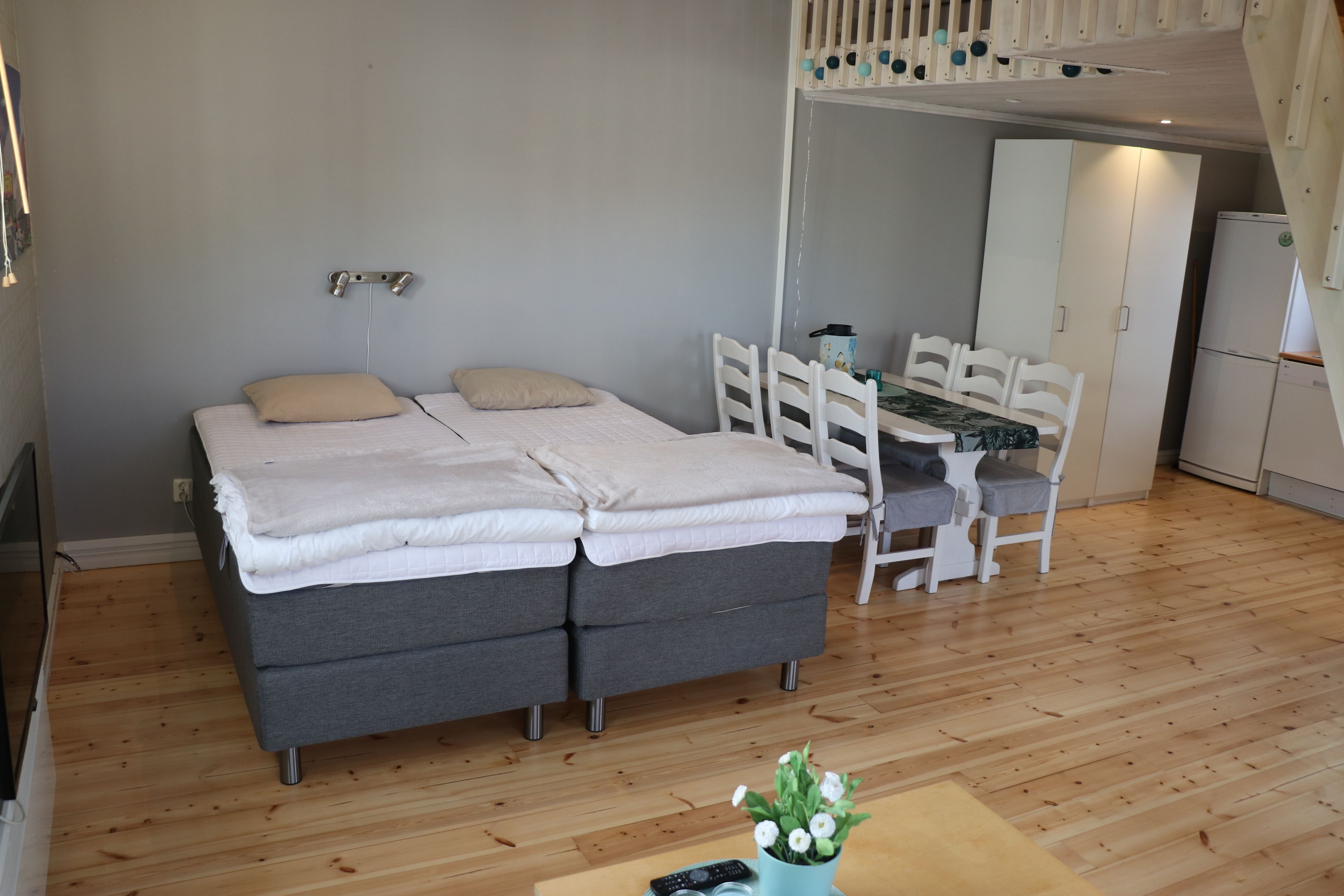 A compact room with a bed, a desk, and a chair.