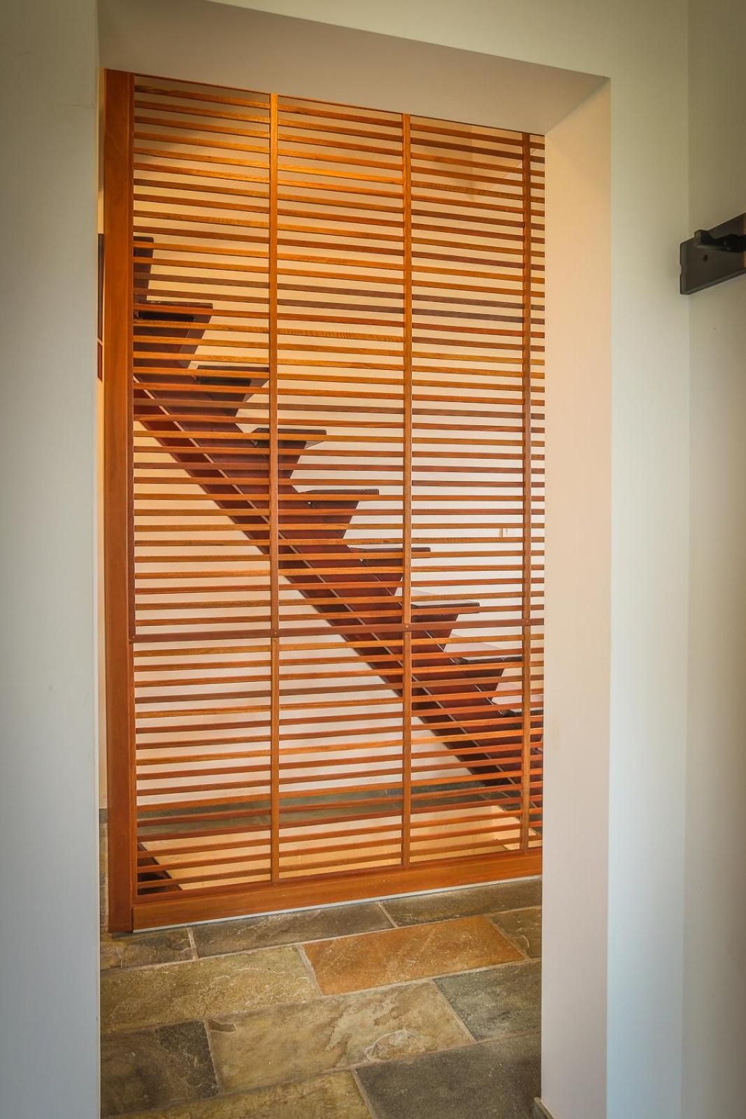A wooden sliding door with a geometric pattern.