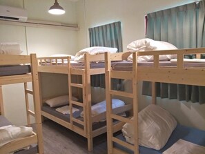 A bunk bed room with a ceiling fan, a window with curtains, and a wall-mounted air conditioner. - B Puli Backpacker Hostel (Puli)