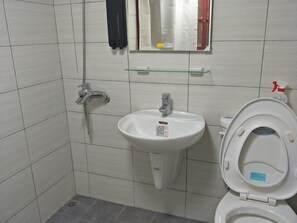 A bathroom with a white sink, a toilet, and a shower. - B Puli Backpacker Hostel (Puli)