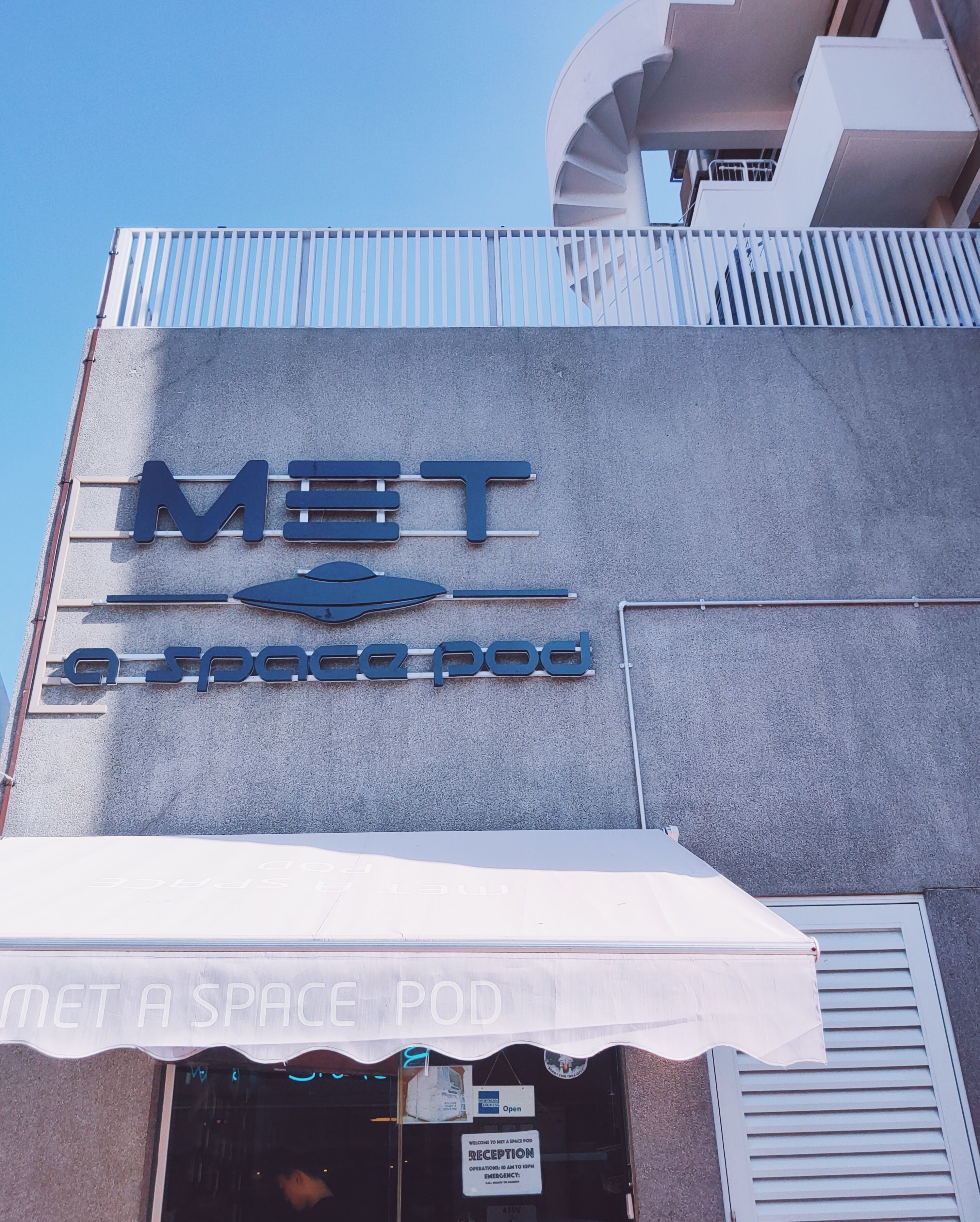 A building with a sign that reads "MET Space Pod."