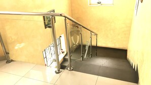 A staircase with metal railings and a tiled floor. - Sweet Savor Hotels & Suites (Lagos)