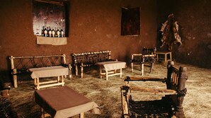 A rustic room with wooden furniture, a bench, a table, and a wall-mounted shelf with bottles. - Degosach Eco Lodge (Lalibela)