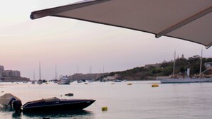 A marina with boats docked, a clear sky, and a cityscape in the background. - Azur Hotel by ST Hotels (Gzira)