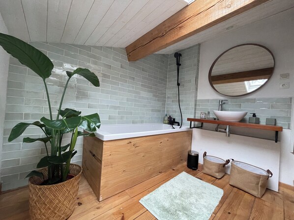 A bathroom with a wooden vanity, a white sink, a round mirror, and a potted plant. - 🌿 Beautiful home with pool in the heart of Médoc Nature, peace&wide open spaces (Saint-Laurent-Médoc)