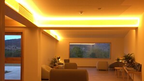 A modern living room with a large window, a sofa, and a coffee table.