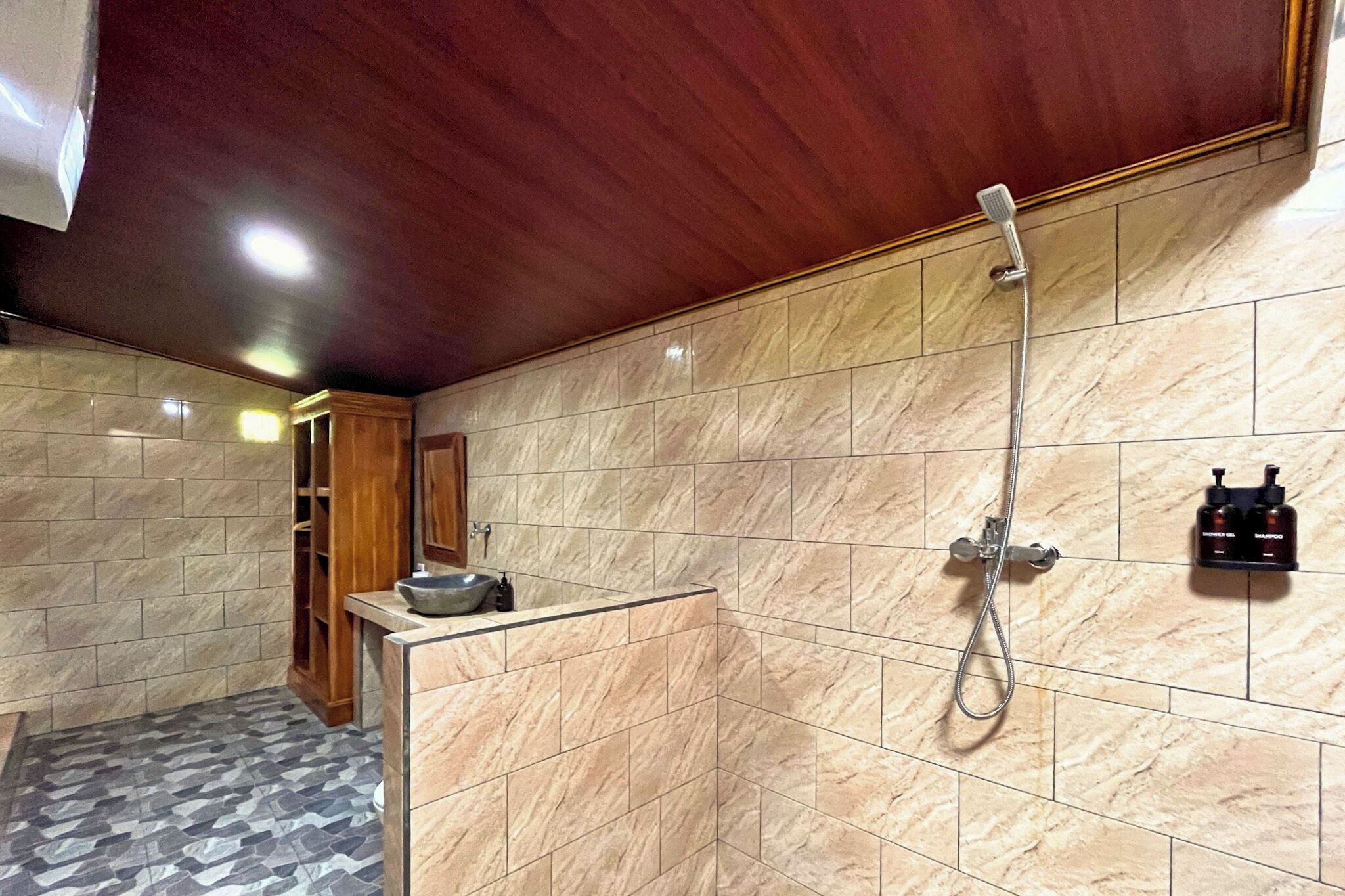 A bathroom with a shower, a sink, and a mirror.