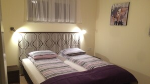 A double bed with a headboard, two pillows, and a purple blanket. - Haus Alpenblick Mölltal (Flattach)