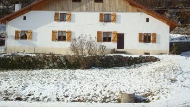 A two-story house with a sloped roof, wooden shutters, and a stone foundation. - House / Villa - LA BRESSE (La Bresse)