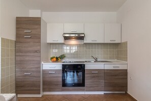 Enjoy cooking in this well-equipped kitchen with a central island, oven, and dishwasher.