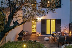 A patio with outdoor furniture, a grill, and a dining table. - Sea view modern spacious lounge house (Premantura)