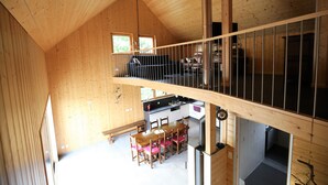 A wooden cabin interior with a dining area, kitchen, and a loft space. - Riesling cottage for 2 to 8 people, ideal for families,  (Rouffach)