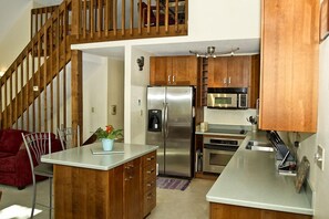 Enjoy cooking in this well-equipped kitchen with an island and stainless steel appliances.