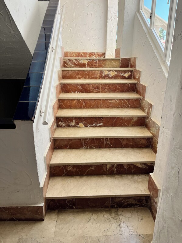 A staircase with marble steps and white walls. - Stunning sea views & large ground floor terrace, 30m from the beach (Marbessa)