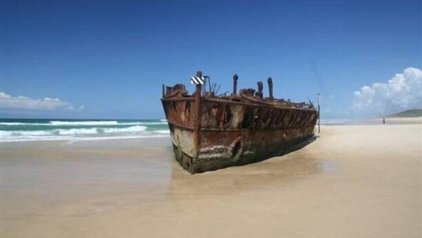 A rusted shipwreck on a beach. - K'GARI (FRASER ISLAND) My Island Home. Sleeps 14. Situated in Eurong  (Eurong)